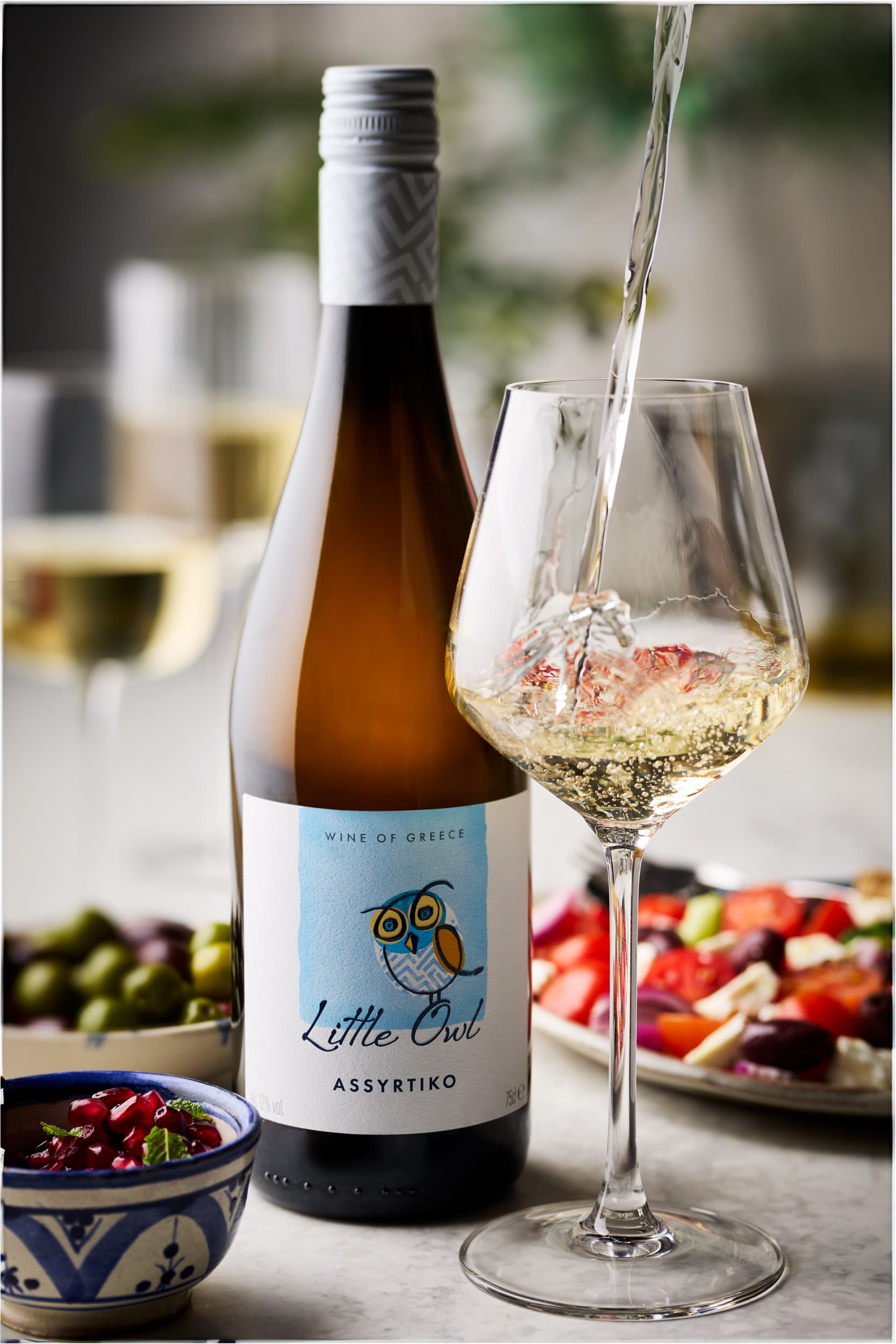 Little Owl Assyrtiko wine being poured
